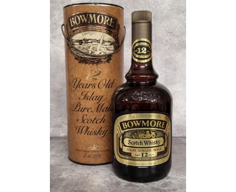 A bottle of Bowmore 12 Year Old Islay Pure Malt Scotch Whisky, 1980's bottling, 1 litre, 43% vol. in tube. Excellent conditio