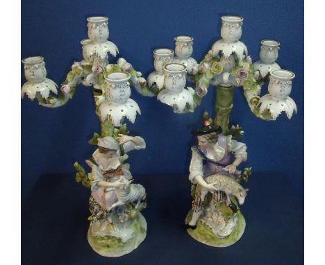 Pair of 19th C continental ceramic four branch candelabra depicting couple holding lambs sat upon the base of a tree with blu