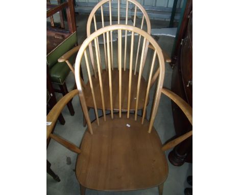 Two elm Ercol low seated stick back armchairs 