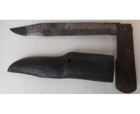 A World War One period German folding trench knife: with 20cm single edged blade, lacking cross guard, with chequered grips, 