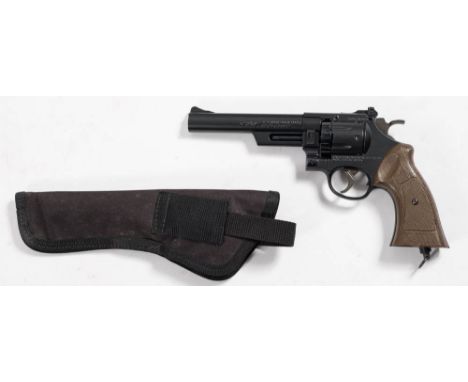 A Daisy Powerline model 44 CO2 air pistol .177 calibre: of metal construction with brown plastic grips complete with associat