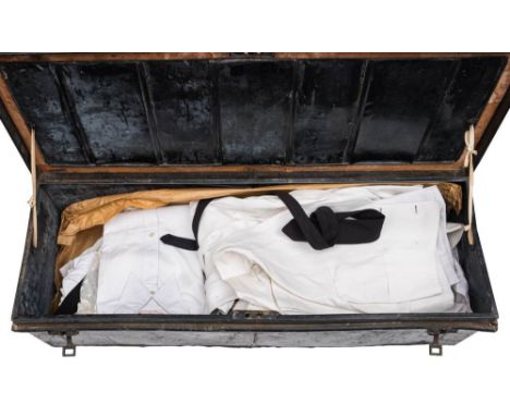 A tin trunk inscribed 'R L Garnons-Williams. HMS Tamar': containing a quantity of Mess shirts and waistcoats etc.*Notes- Capt