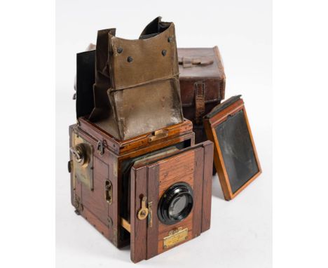 A mahogany and brass Ensign Popular reflex 'Tropical Model'  three quarter plate camera: fitted with Anastigmat 6 inch lens, 