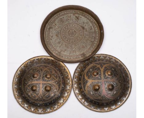 Two Indo-Persian steel dhals: of circular outline with inlaid niello enamel decoration and four circular bosses, each 28cm di