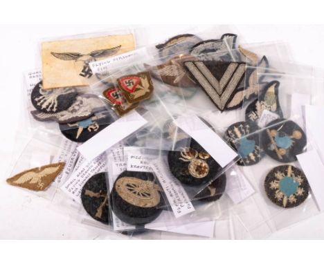 A collection of various German military cloth badges including: aircraft equipment administration branch, search light equipm