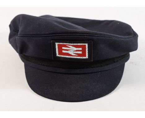 A British Rail peaked cap: together with a wooden rattle and an oil lamp (3)