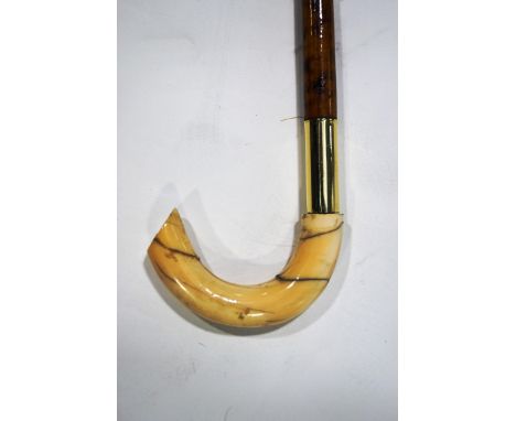 A bamboo walking stick with ivory handle, brass collar and tip