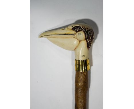 A walking stick with resin pelican's head handle