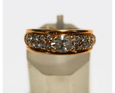 A diamond set dress ring, stamped 'Boucheron', 'B353' over '17716' and a makers mark, the oval cut central diamond, calculate