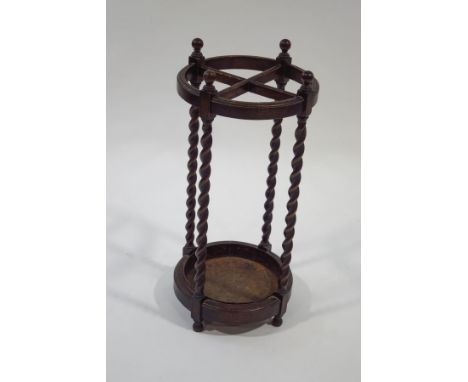 An early 20th century oak round stick stand, with barley twist supports, 71cm high