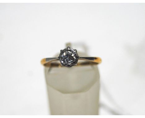 An early 20th century gold and diamond solitaire ring, the old-cut stone approximately 0.32cts, set in white on a yellow shan