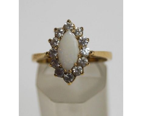 A 9 carat gold opal and cubic zirconia cluster ring, finger size O1/2, 3.4 g gross, cased