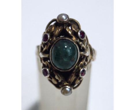 A cabochon emerald set ring, with red stone and seed pearl points, probably Austro Hungarian, finger size M, cased