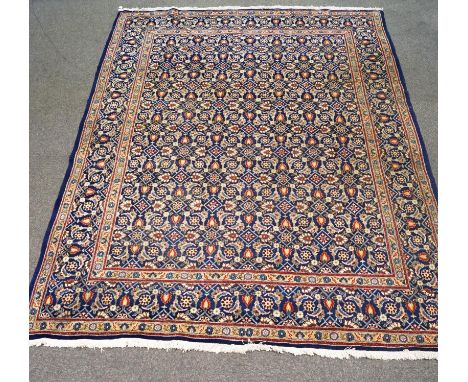 A large modern carpet with Persian style decoration on a blue ground, 372cm x 270cm