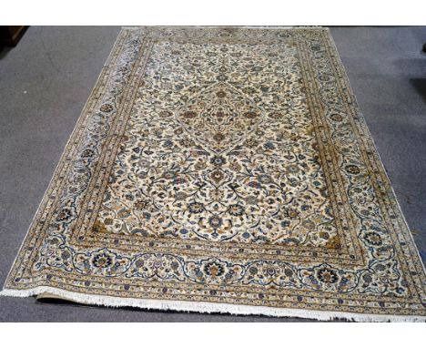 A large 20th century Persian style modern carpet, with stylised blue flower decoration on a cream field 409cm x 296cm 