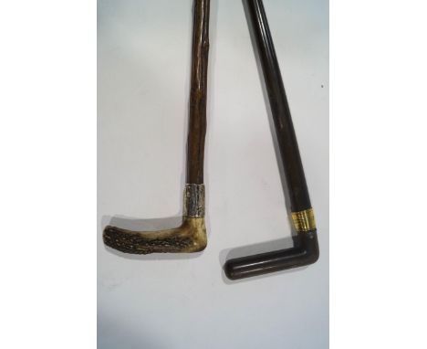 A walking stick with horn handle and silver collar, and a walking stick with brass collar