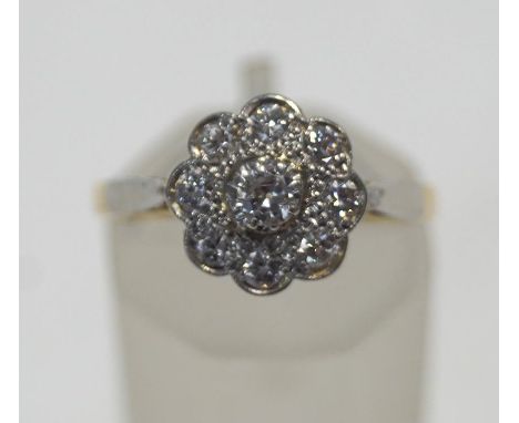 An early 20th century gold and diamond daisy cluster ring, the nine round brilliant diamonds approximately 0.66cts total, gra