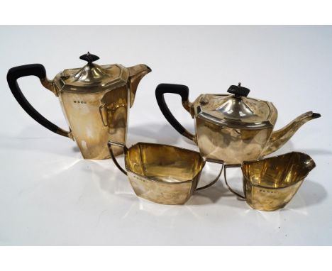 A matched silver four piece tea service, Birmingham 1934, hot water jug 1933, of rounded rectangular out line and plain form,