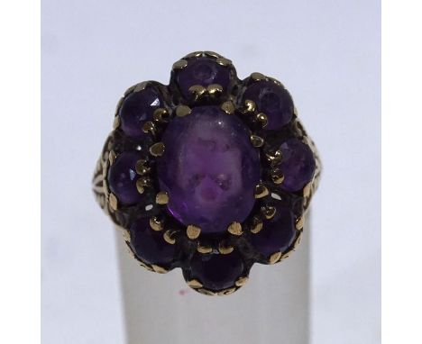 A nine stone amethyst cluster ring, finger size P, 6 g gross, cased