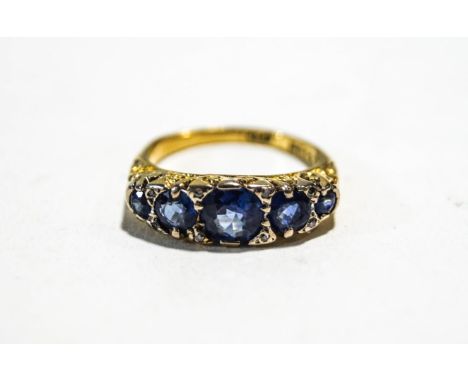 An 18 carat gold five stone sapphire ring, the graduated round cuts with single cut diamond points between, finger size P, 5.