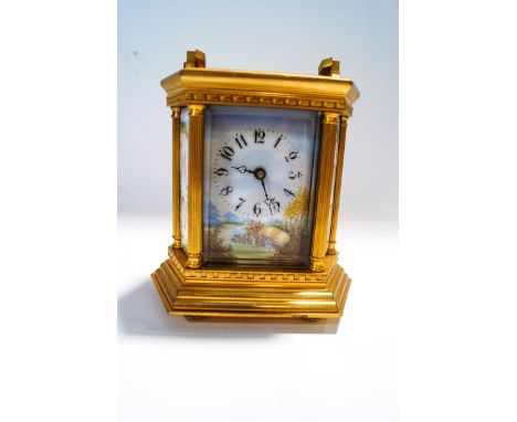 A 20th Century French brass carriage clock, inset with six enamel panels, decorated with cherubs in a garden setting, 17cm hi