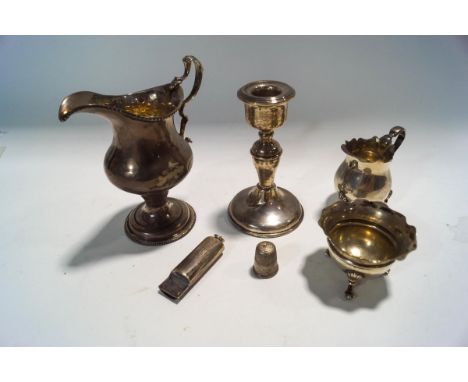A late Victorian silver miniature cream jug, Birmingham 1896, 6 cm high; with a Georgian helmet shaped silver cream jug; mark
