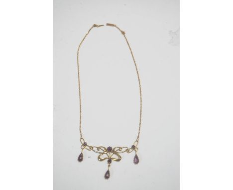 An Edwardian amethyst pendant necklace, tagged '15ct', showing Art Nouveau influence, 38 cm long, 6 g gross