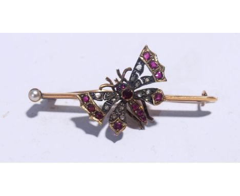 A late Victorian rose diamond and ruby butterfly bar brooch, with a split pearl (untested and unwarrranted) terminal to the b