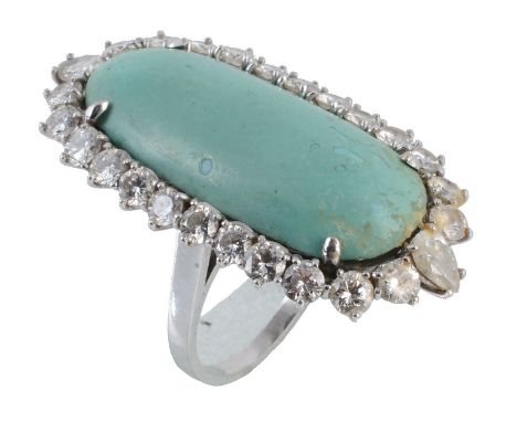 A turquoise and diamond cluster ring, the oval turquoise panel within a surround of brilliant cut diamonds with two pear cut 