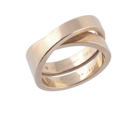  A Nouvelle Vague Paris ring by Cartier, the polished crossover band signed Cartier and numbered J83917, stamped 750, finger 