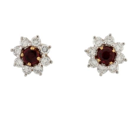  A pair of ruby and diamond ear studs by Garrard & Co., the circular shaped ruby in a claw setting within a removable surroun
