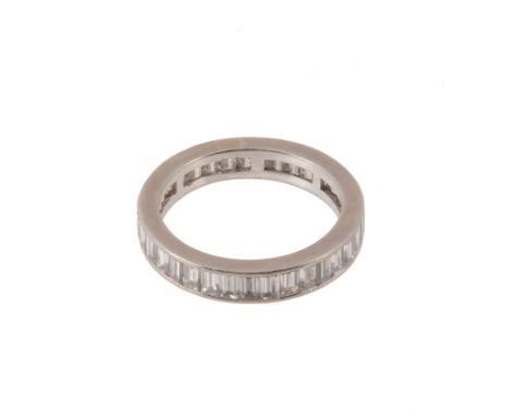  A diamond eternity ring, set throughout with baguette cut diamonds, approximately 1.70 carats total, within a polished surro