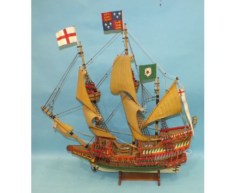 A scratch-built wooden model of the 'Golden Hind' on stand, 61cm wide, 61cm high, sold together with two volumes of 'Plank-on