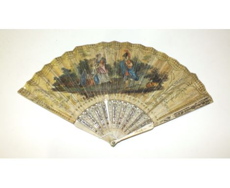 An 18th century fan, the guards and sticks carved and heightened in gold and silver, the chicken skin leaf overlaid with silk