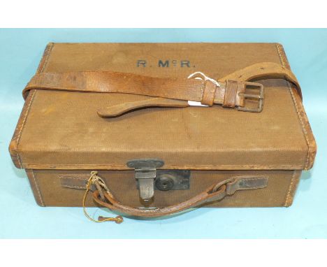 A calf and canvas-covered cartridge magazine with leather strap initialled R Mc R and bearing paper label for William Evans, 