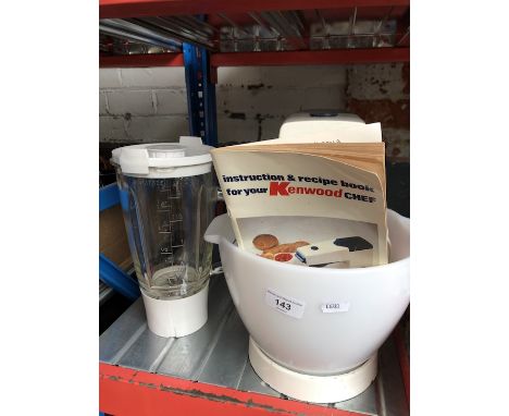 A Kenwood Chef mixer bowl with various attachments and instructions manual 