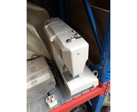A Toyota 2700 series sewing machine with pedal, instructions manual and some accessories 