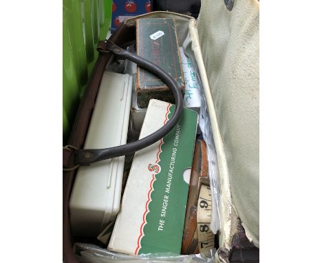 A bag with vintage Singer attachments and other tools 