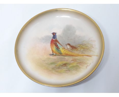 A Royal Worcester porcelain dish hand painted with a pheasant and signed by the artist, diam. 9cm. Condition - scratch just a