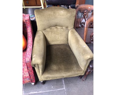 A green upholstered button back armchair 