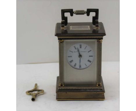 A MATTHEW NORMAN OF LONDON CARRIAGE TIMEPIECE in a classical column brass case, white dial with Roman numerals, fitted an ele