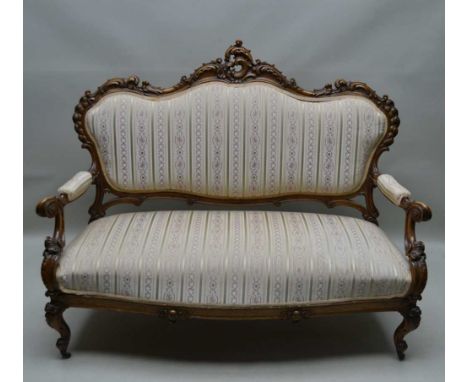 A 19TH CENTURY CARVED SHOW WOOD TWO-SEATER SALON SOFA, acanthus carved back, scroll carved arms on cabriole supports, upholst