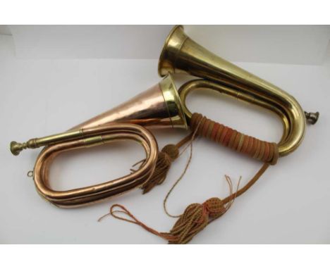 AN EARLY 20TH CENTURY BRASS BUGLE WITH BOUND TASSELLED CHORD together with a 'John Grey' of London copper &amp; brass bugle (