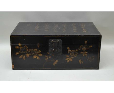 A 20TH CENTURY CHINESE TRUNK, black ground with calligraphic inscription characters painted to hinged lid, with iron side car