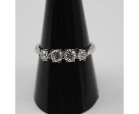 AN 18CT WHITE GOLD FOUR STONE DIAMOND RING, brilliant cut stones, size 'Q 1/2', 4g 