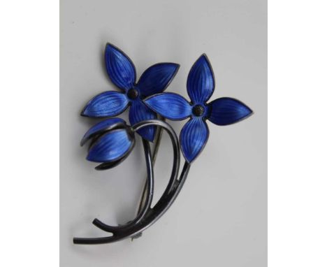 CONSIDERED TO BE AKSEL HOLMSEN, A NORWEGIAN SILVER & BLUE GUILLOCHE ENAMEL FLORAL BROOCH, two open and one closed flowerhead,