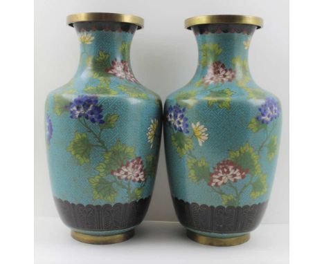 A PAIR OF EARLY 20TH CENTURY CHINESE CLOISONNE VASES, the brass bodies of baluster form, enamelled upon a blue ground with po