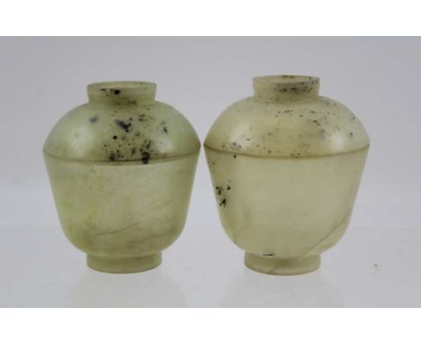 TWO CHINESE JADE TEA BOWLS &amp; COVERS, the translucent pale jade bowl having a flared body on a short straight foot, each f