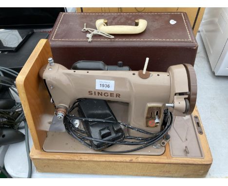 A RETRO SINGER SEWING MACHINE WITH WORK LIGHT AND CARRY CASE 