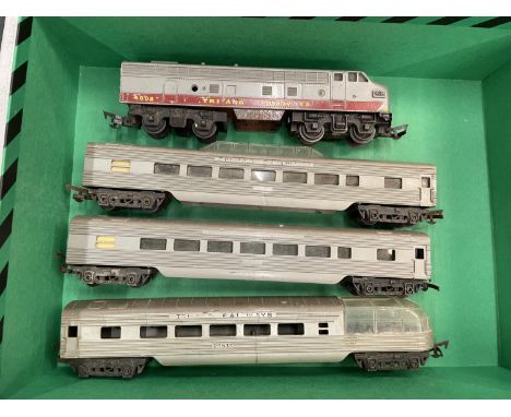 A TRI-ANG RAILWAYS CANADIAN PACIFIC ENGINE AND THREE CARRIAGES 